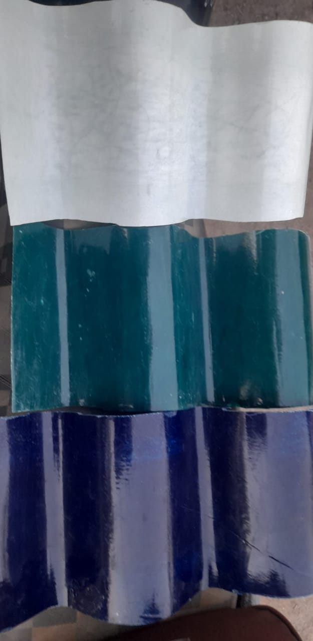 Three FRP corrugated sheet samples – off-white, teal, and blue – showcasing colour options.
