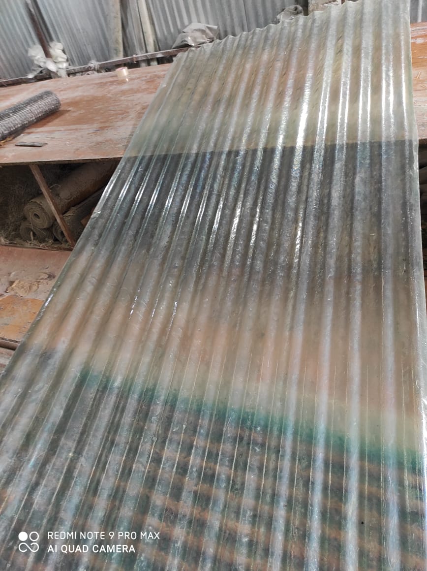 Translucent FRP corrugated sheet with greenish-blue band, showing corrugated structure in storage.