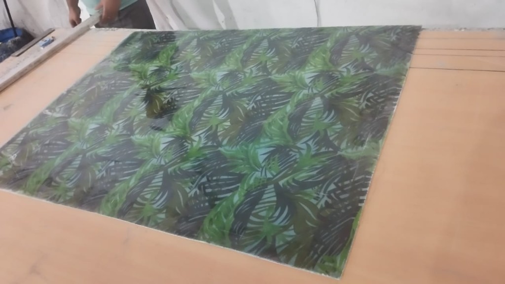 Flat FRP printed panel with dense tropical leaf print, ready to be cut for decorative roofing, wall panels, or partitions.