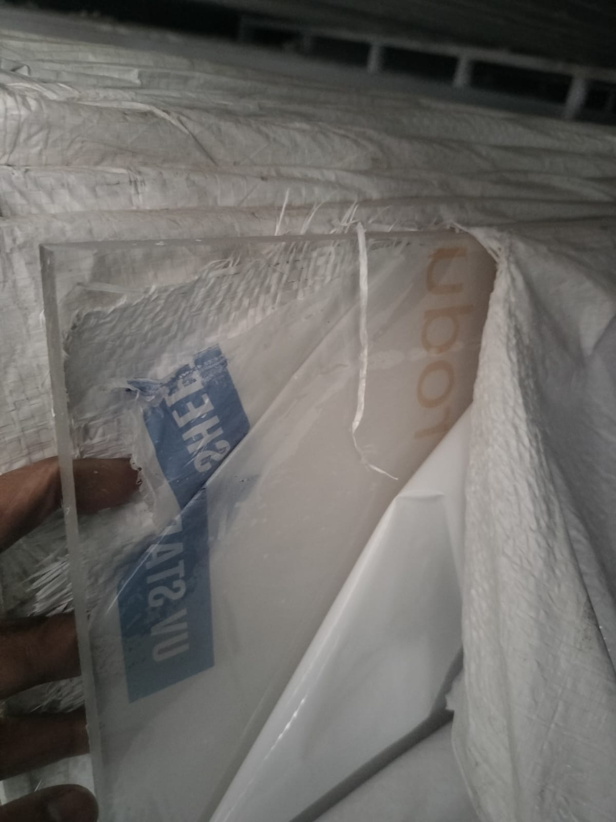 Polycarbonate solid sheet in protective packaging with UV marking, ready for dispatch.